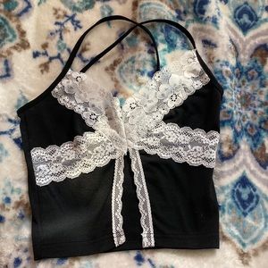 black crop top with white lace, open on the bottom in the front.